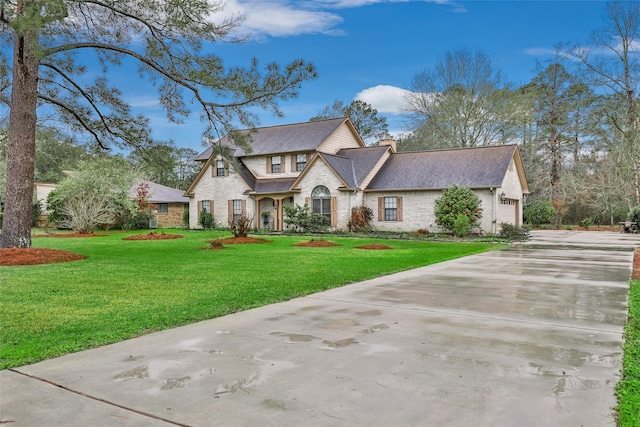 view of front of property with a garage and a front lawn