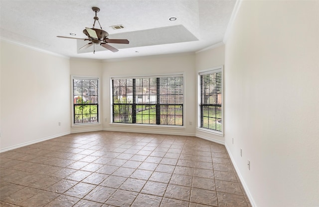 empty room featuring crown molding, a textured ceiling, a raised ceiling, and ceiling fan