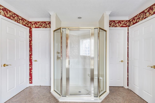 bathroom with tile patterned flooring, crown molding, and walk in shower