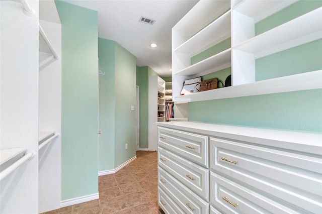 spacious closet with light tile patterned floors