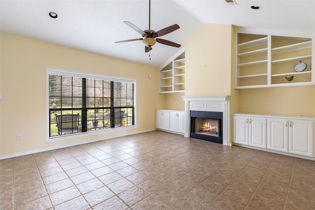 unfurnished living room with built in shelves, vaulted ceiling, ceiling fan, and light tile patterned flooring