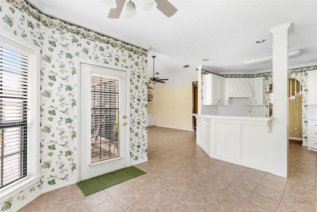 kitchen with white cabinetry, ceiling fan, plenty of natural light, and kitchen peninsula