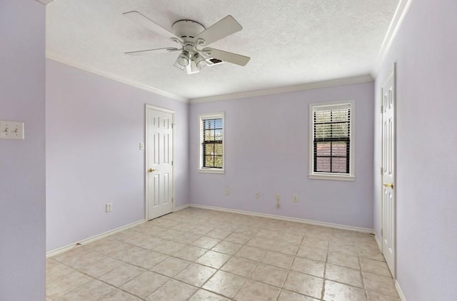 spare room with ornamental molding, light tile patterned flooring, ceiling fan, and a textured ceiling