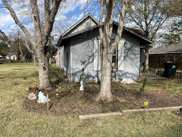 view of property exterior with a lawn