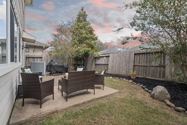 yard at dusk featuring a patio and outdoor lounge area