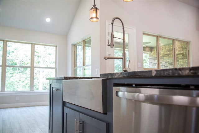kitchen with baseboards, dishwasher, lofted ceiling, hanging light fixtures, and recessed lighting