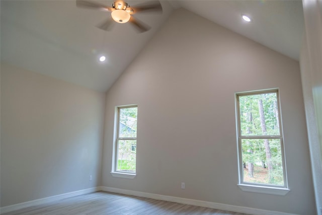 unfurnished room featuring light wood-style floors, recessed lighting, high vaulted ceiling, and baseboards