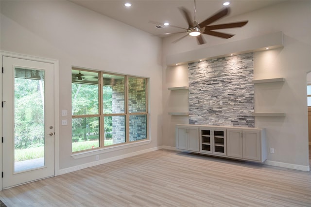 bar featuring light wood-type flooring, baseboards, a ceiling fan, and recessed lighting
