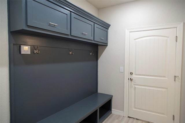 mudroom featuring light wood-style flooring and baseboards