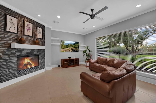 7611 Kings River Ln, Humble, TX 77346 - tiled living room featuring ornamental molding, recessed lighting, a ceiling fan, a stone fireplace, and baseboards