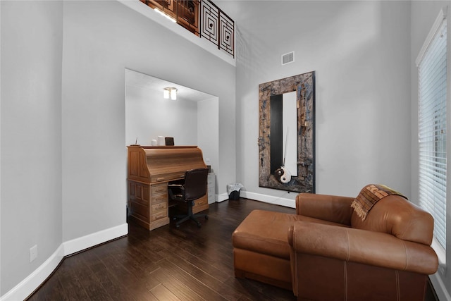 7611 Kings River Ln, Humble, TX 77346 - living area featuring baseboards, a high ceiling, wood finished floors, and a desk