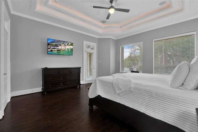 7611 Kings River Ln, Humble, TX 77346 - bedroom featuring a tray ceiling, crown molding, wood finished floors, baseboards, and a ceiling fan