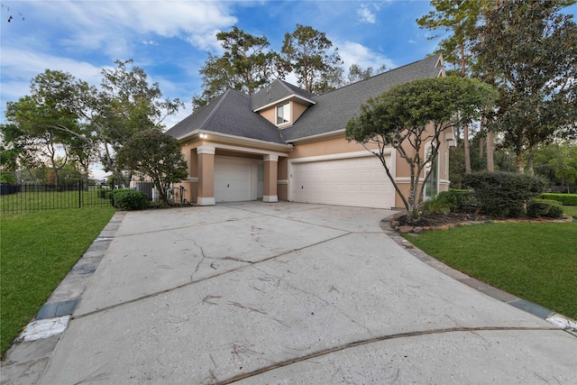 7611 Kings River Ln, Humble, TX 77346 - view of front facade with stucco siding, an attached garage, concrete driveway, and roof with shingles