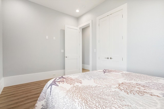 bedroom featuring hardwood / wood-style flooring and a closet