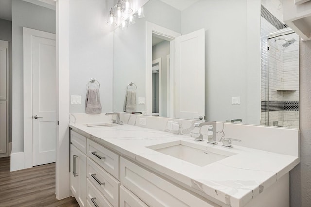 bathroom featuring vanity, a shower, and wood-type flooring