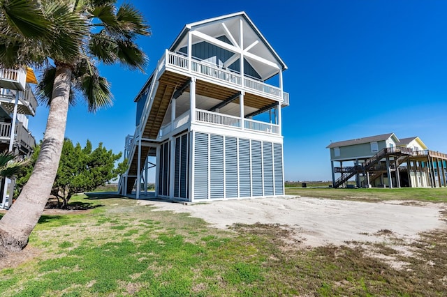 back of property featuring a yard