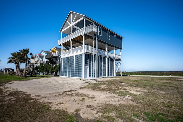 back of house featuring a balcony