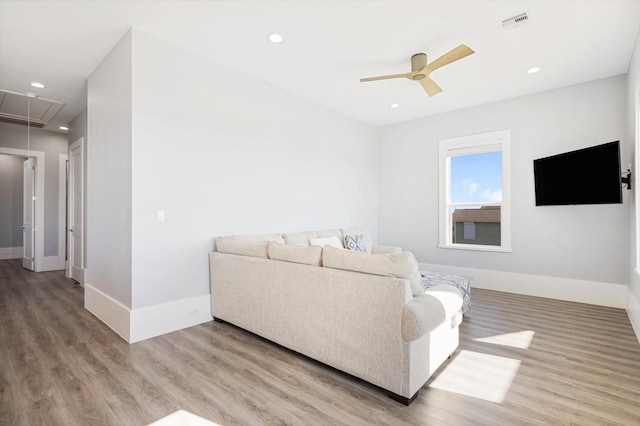 living room featuring ceiling fan and light hardwood / wood-style flooring