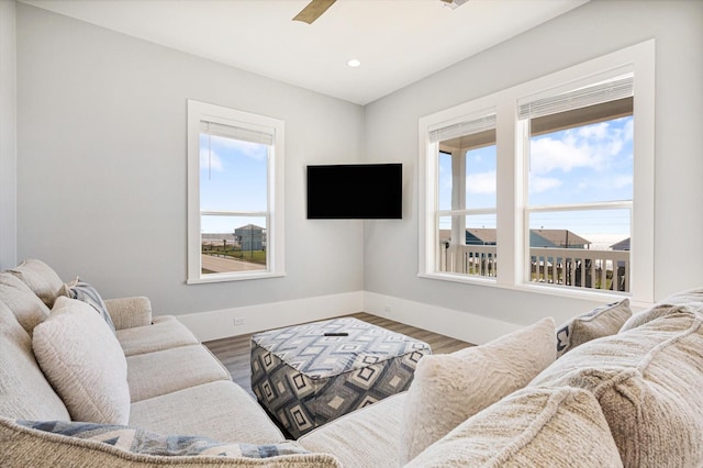 living room with hardwood / wood-style floors and ceiling fan