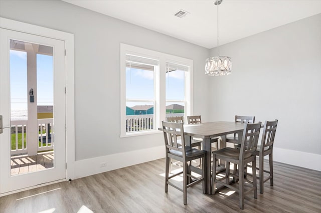 dining room with a chandelier and hardwood / wood-style floors