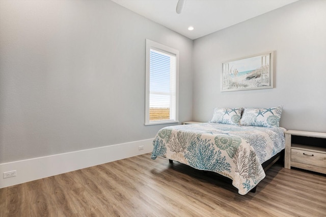 bedroom with hardwood / wood-style flooring and ceiling fan