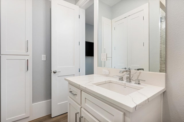 bathroom featuring vanity and hardwood / wood-style floors