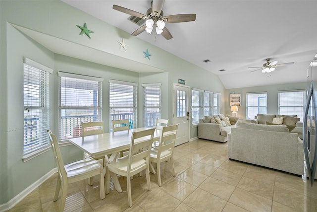 dining room featuring lofted ceiling, ceiling fan, and light tile patterned floors