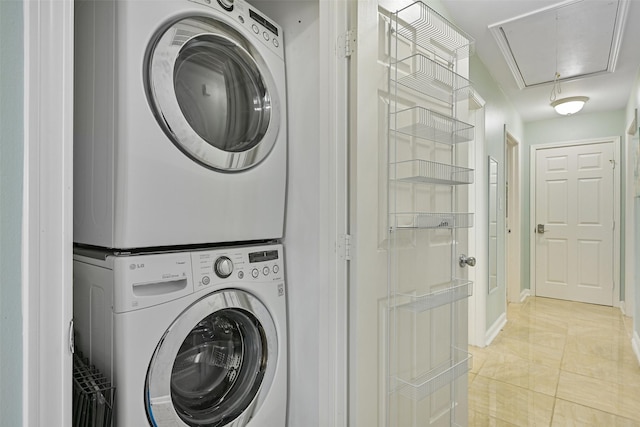 washroom featuring light tile patterned floors and stacked washer and clothes dryer