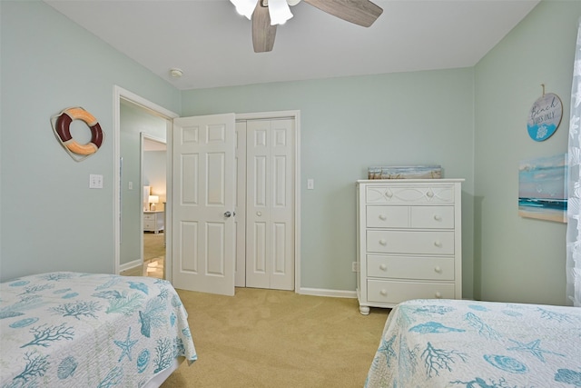 carpeted bedroom featuring a closet and ceiling fan