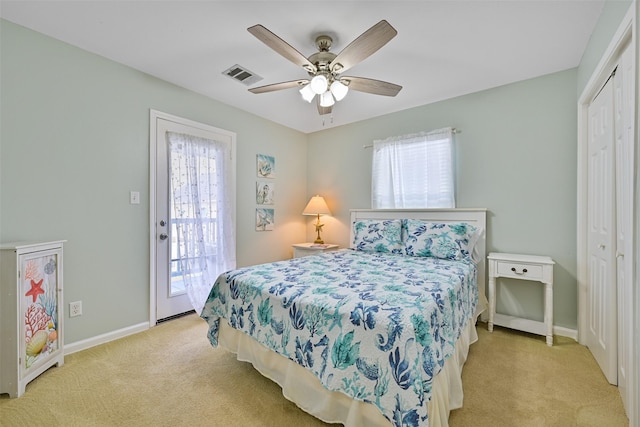 bedroom featuring multiple windows, a closet, access to outside, and light colored carpet