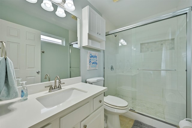 bathroom with tile patterned floors, toilet, vanity, and walk in shower