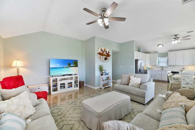23178 Fresca St, Galveston, TX 77554 - living area featuring a ceiling fan, lofted ceiling, baseboards, and light tile patterned flooring