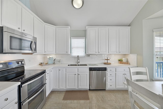 23178 Fresca St, Galveston, TX 77554 - kitchen with a sink, stainless steel appliances, tasteful backsplash, and white cabinets