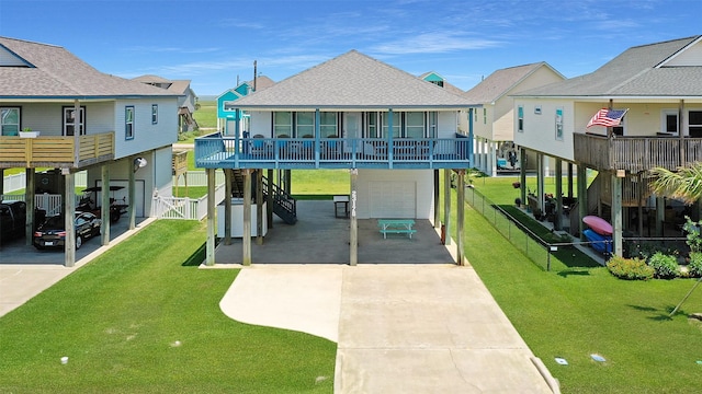 23178 Fresca St, Galveston, TX 77554 - view of front of property with an attached garage, concrete driveway, roof with shingles, a carport, and a residential view