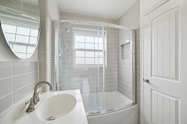 bathroom with bath / shower combo with glass door and vanity