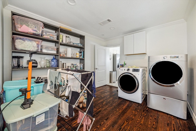 washroom featuring dark hardwood / wood-style flooring, crown molding, and washer and dryer