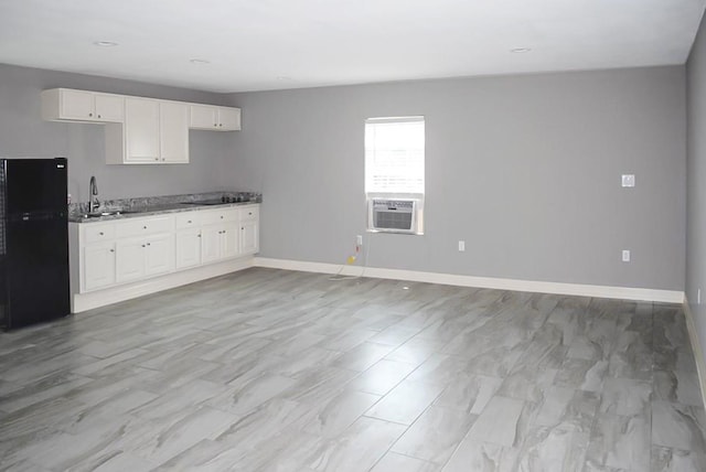 kitchen featuring sink, cooling unit, white cabinets, and black appliances