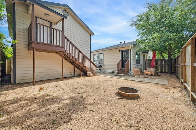 back of property featuring a patio area and a fire pit