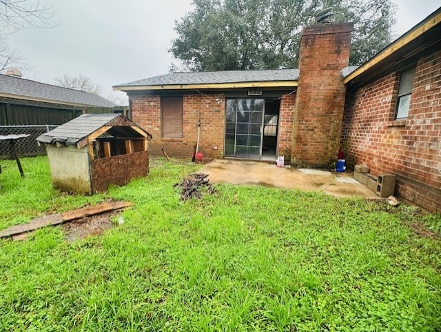 rear view of house with a yard