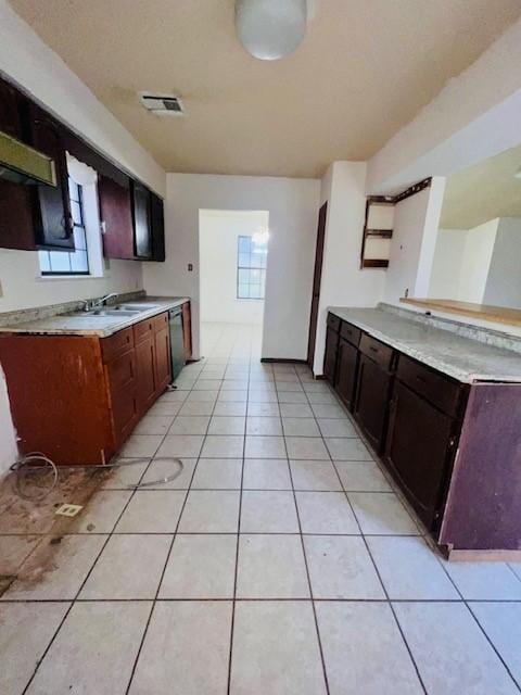 kitchen featuring a healthy amount of sunlight, sink, dark brown cabinets, and light tile patterned floors