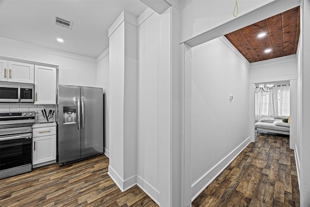 kitchen with dark hardwood / wood-style flooring, a notable chandelier, stainless steel appliances, and white cabinets