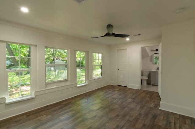 spare room with ornamental molding, dark hardwood / wood-style floors, and ceiling fan