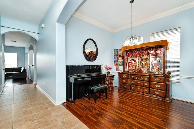 misc room featuring hardwood / wood-style floors, ornamental molding, and a chandelier