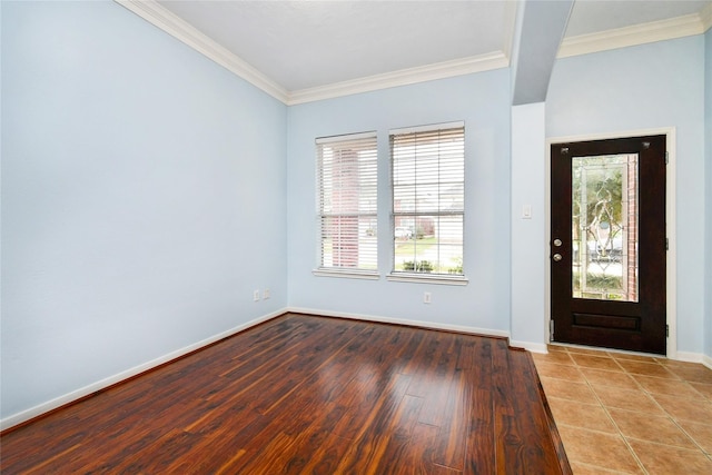 foyer with ornamental molding and hardwood / wood-style floors