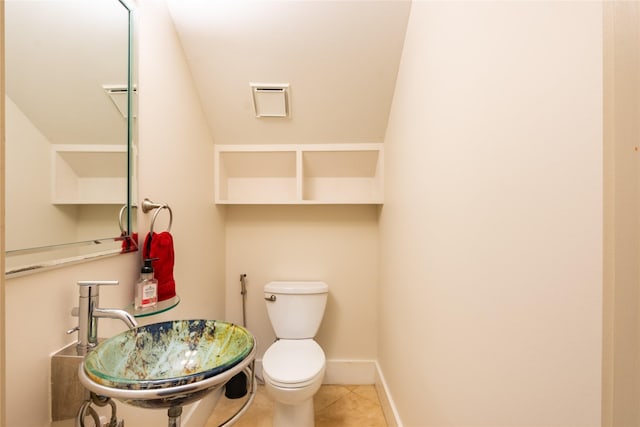 bathroom featuring toilet, tile patterned flooring, and sink