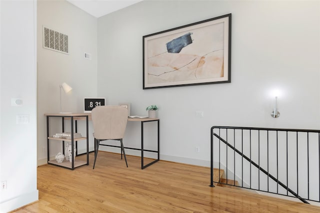 office space with light hardwood / wood-style floors