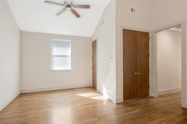 spare room featuring vaulted ceiling, ceiling fan, and light wood-type flooring