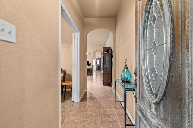 corridor featuring light tile patterned flooring