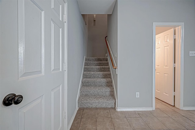 stairway featuring tile patterned flooring