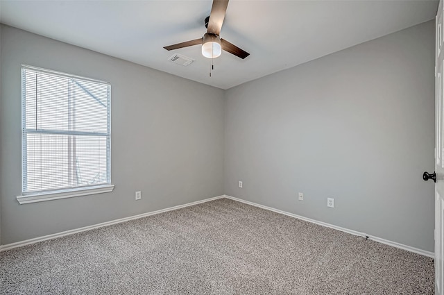 empty room with ceiling fan and carpet floors